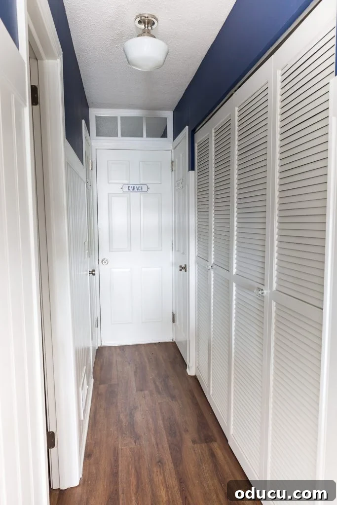 My Party Style Sanctuary 2 Organized hallway with a white paneled lower wall, navy blue upper wall, and white doors, one labeled 'Party,' hinting at efficient home entertaining storage.