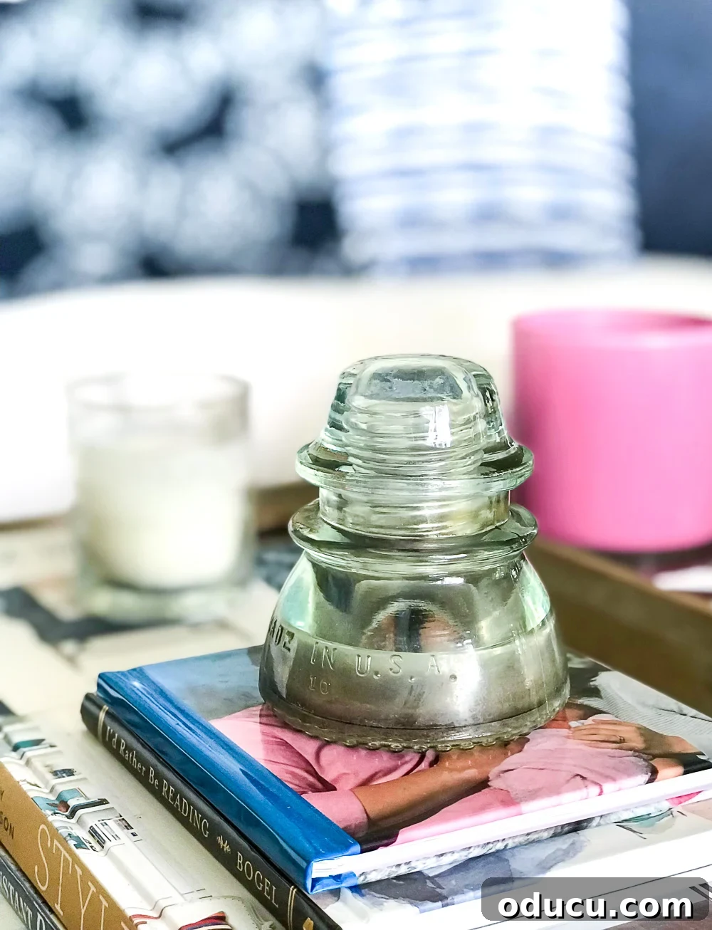 Echoes in Every Element 14 What can you do with a glass insulator? Create meaningful home decor to transform your house into a happy and loving home, like this one on a stack of books.