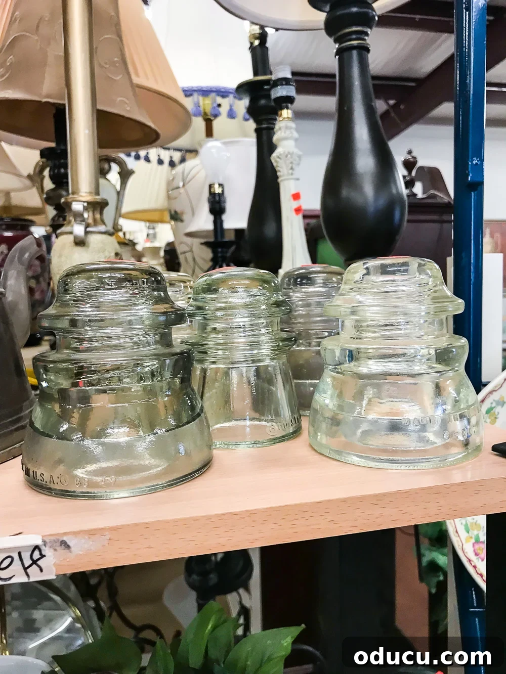 Echoes in Every Element 4 Various glass insulators found at a thrift store, ready to be repurposed and used in home decorating for a touch of vintage charm.