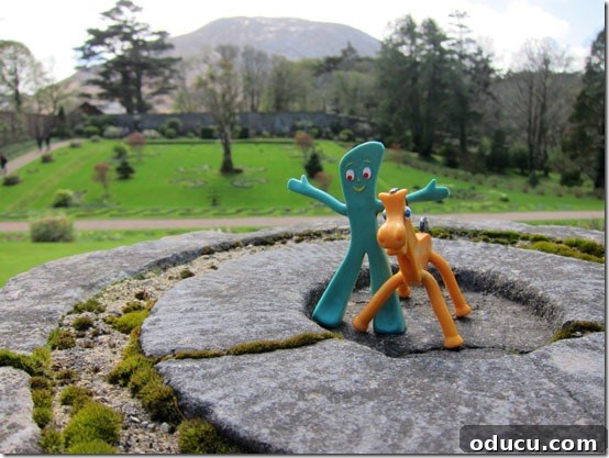 Ireland-Kylemoor-Abbey- Gumby and Pokey, the travel mascots, perched on a rock overlooking Kylemore Abbey