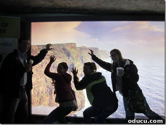 Ireland-Cliffs-of-Mohr-Shen Silhouetted family enjoying an indoor panoramic view of the Cliffs of Moher