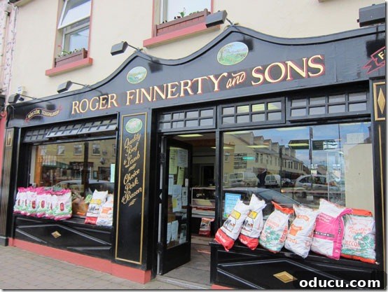 Ireland-storefront-butcher Traditional Irish butcher shop with bags of potatoes displayed in the window