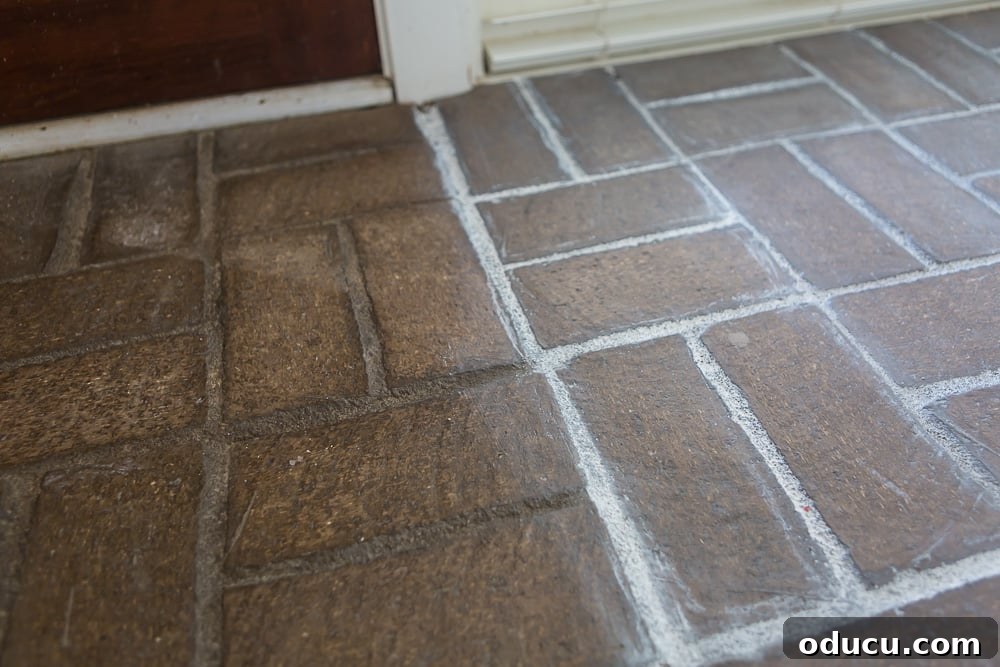 My $14 Whitewashed Brick Floor Makeover 11 Close-up photo showing the before and after of the brick floor side by side with grout paint and without.