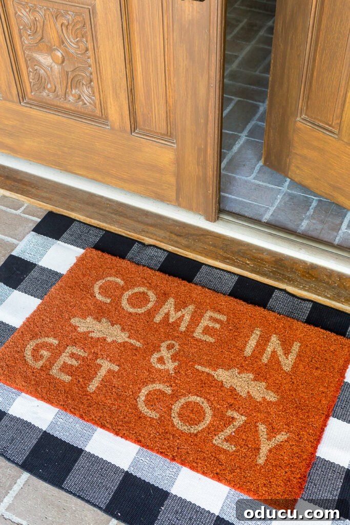 Autumn Nesting: Decor Ideas for Fall 2 Welcoming orange fall door mat on a home's front porch entry, 'Come In and Get Cozy'