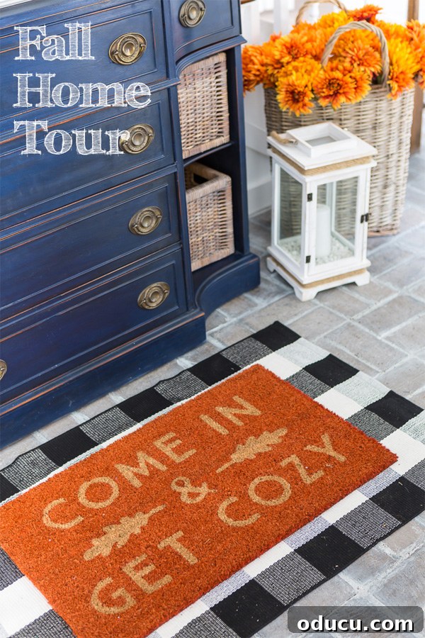 Autumn Nesting: Decor Ideas for Fall 15 Blue sideboard in a home's entry foyer with a 'Come In and Get Cozy' fall doormat