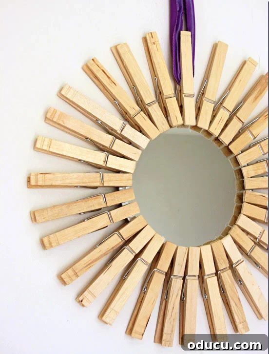 How-to-make-a-diy sunburst-mirror-using-clothespins. DIY sunburst-mirror-with clothespin frame