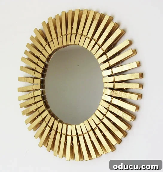 How to make a gold sunburst mirror using clothespins. You can also make them in many different sizes and colors. #Mirrors #repurposeddecor #DIYwallart #dollarstorecrafts Gold Painted clothespins on a mirror to create a creative frame for a mirror