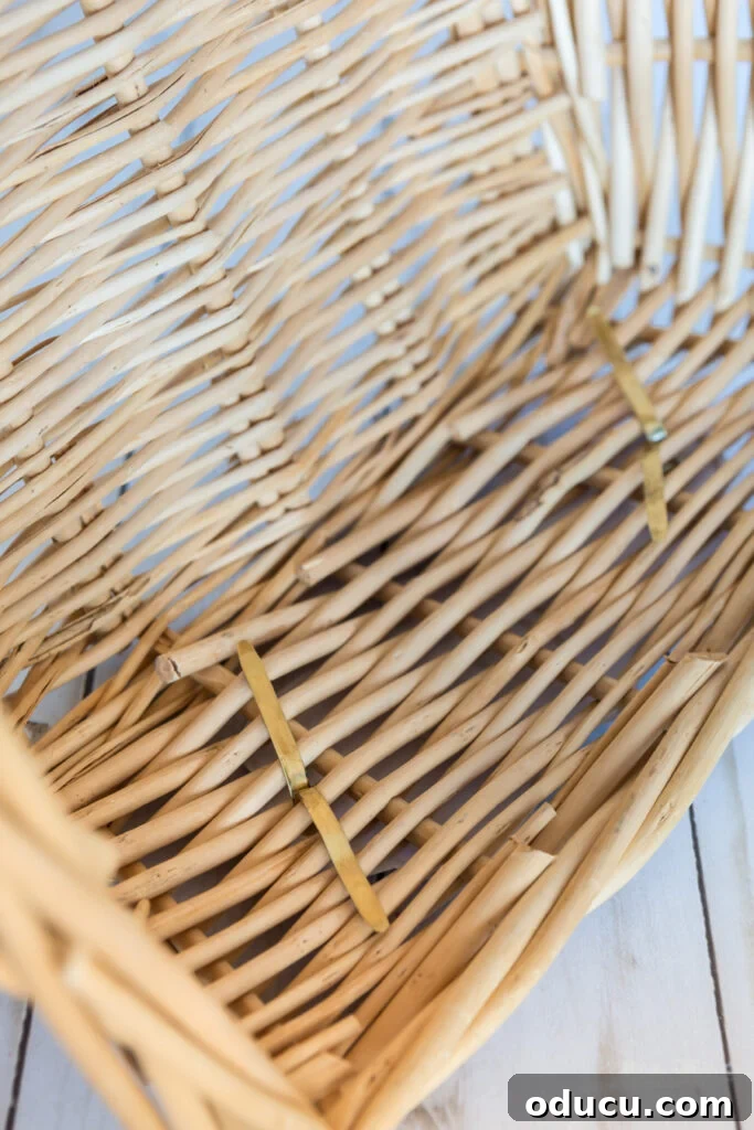 Chic Storage Without the Splurge 14 How to attach a label using a brass fastener to a storage basket.