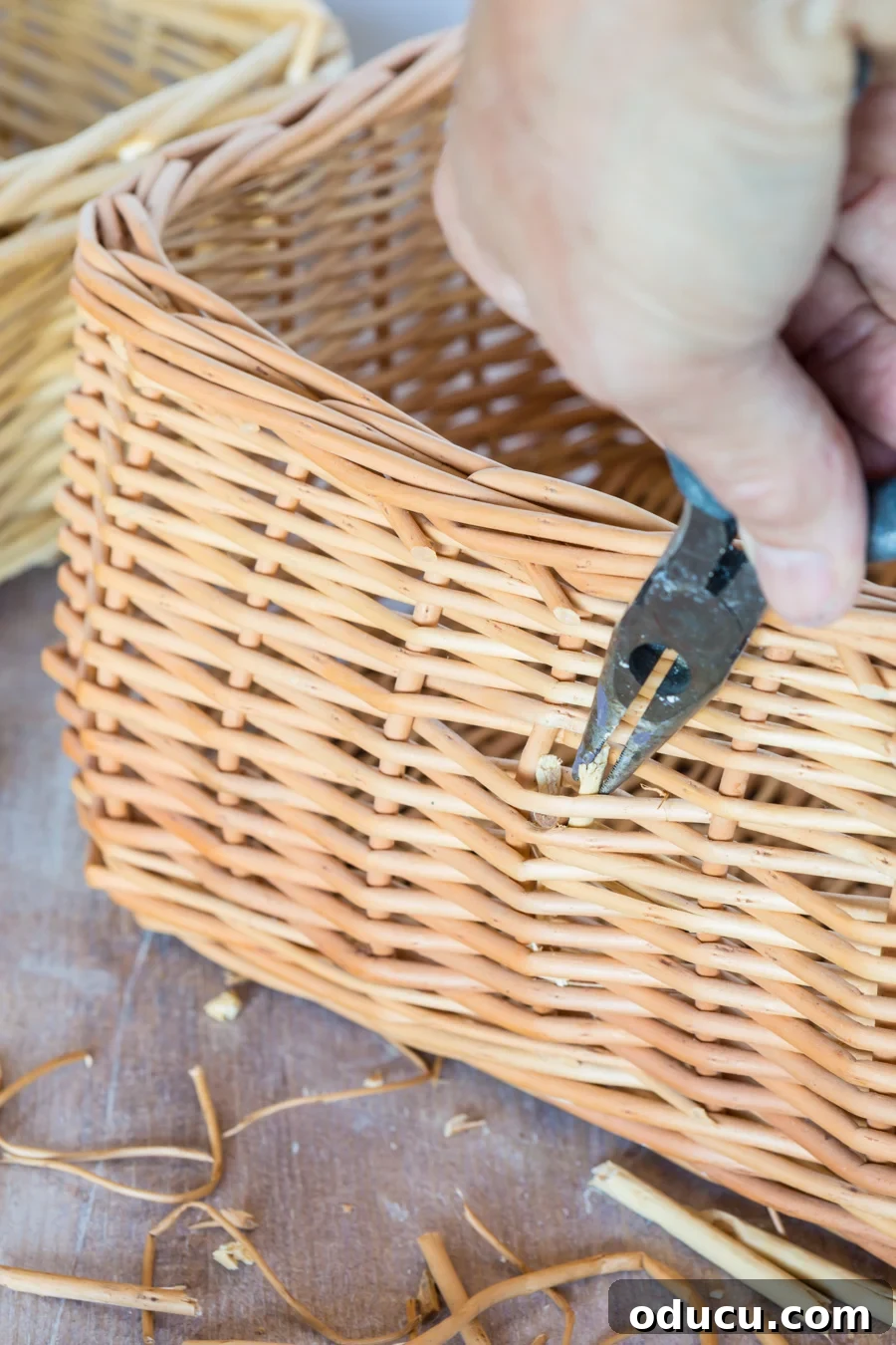 Chic Storage Without the Splurge 9 Removing handle and shim reeds on a wicker basket that will be used for cheap, but decorative storage