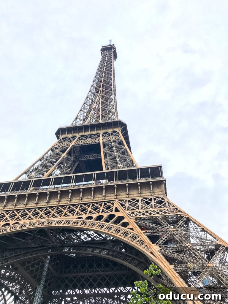 Looking up from the base of The Eiffel Tower in Paris - a breathtaking view of the iconic landmark, highlighting its intricate ironwork.