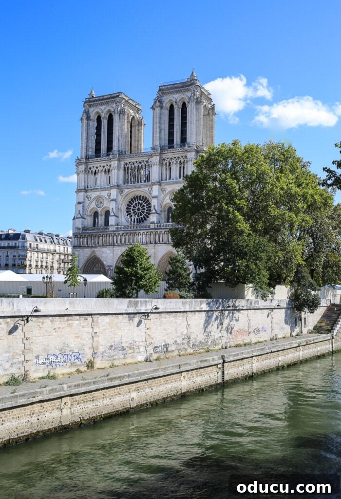A poignant front view of Notre Dame Cathedral in Paris, showcasing its resilience and ongoing recovery after the devastating fire.