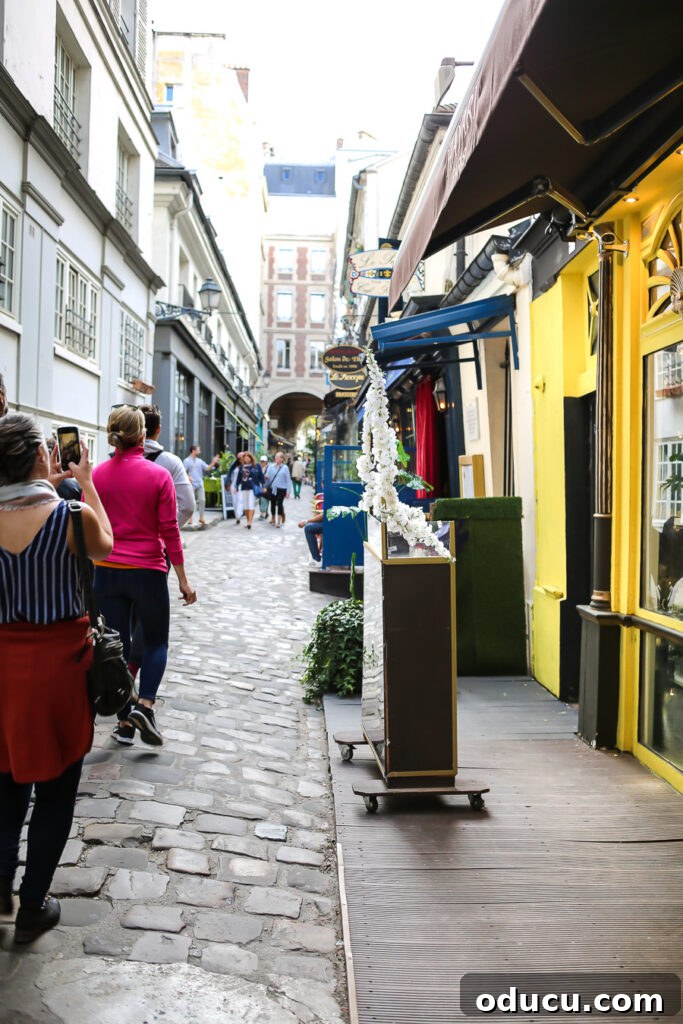 The charming Rue de l'Ancienne Comedie in Paris, a narrow cobblestoned street filled with history and character.