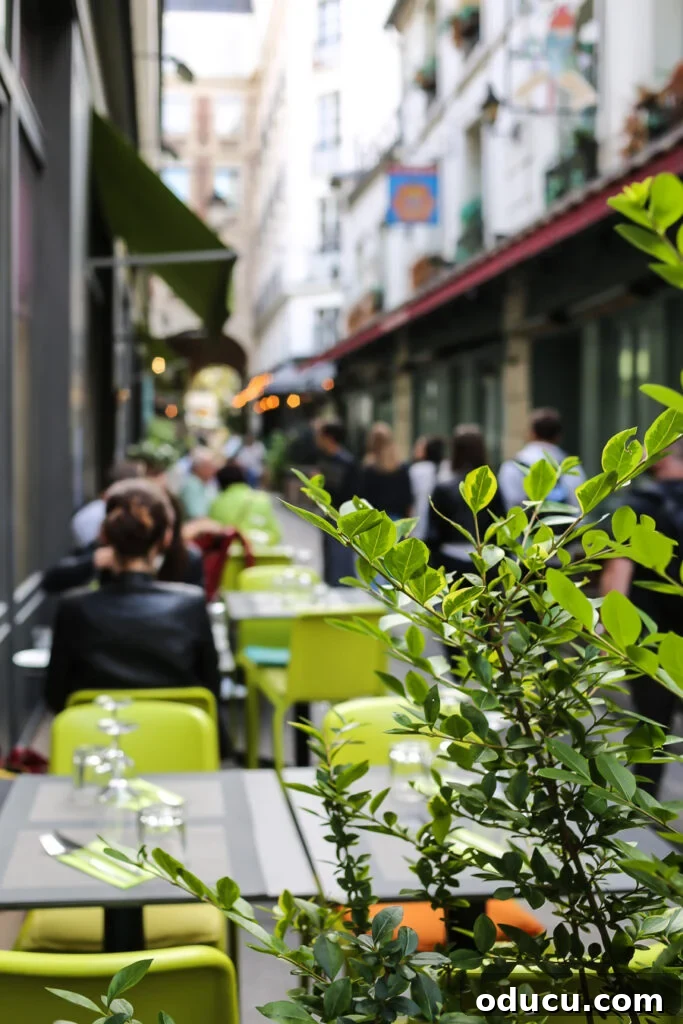 A picturesque tiny cobblestone street in Paris, lined with inviting cafes and charming shops, capturing the essence of local Parisian life.