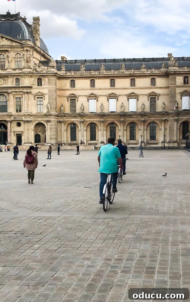 Bike tours in Paris often include a visit to the magnificent courtyard of the Louvre, showcasing its grand architecture and iconic pyramids.