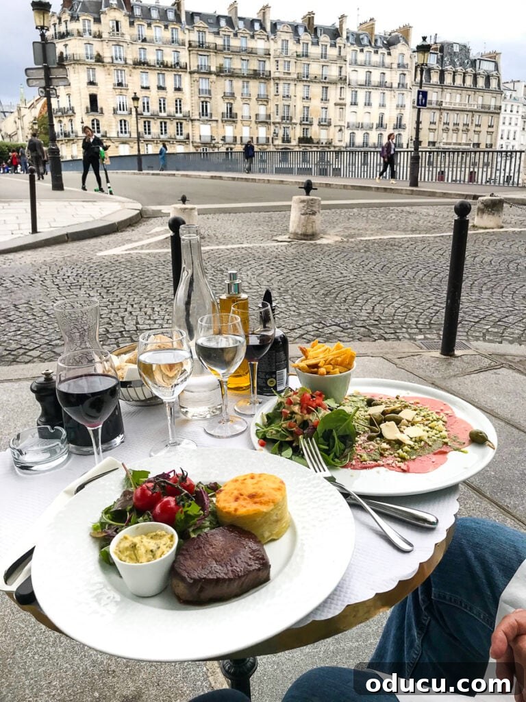 Savoring dinner at a small, chic round table at an outdoor cafe in Paris, enjoying the ambiance and observing city life.