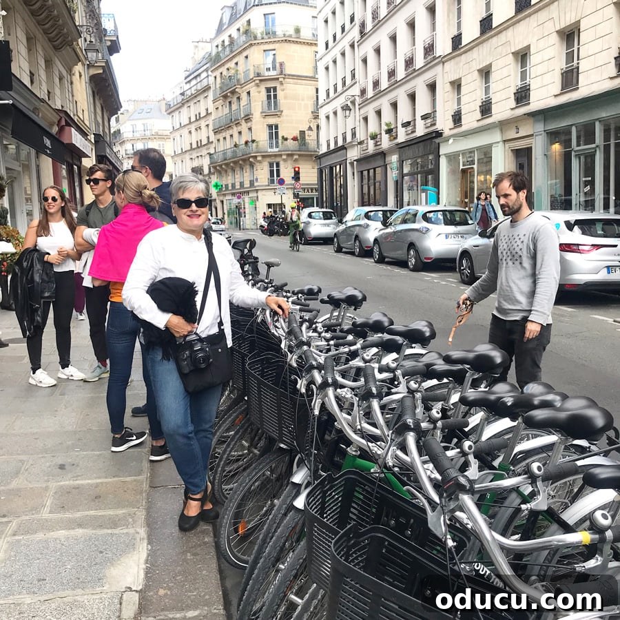 Diane of In My Own Style blog in Paris, excitedly preparing to embark on a memorable bike tour adventure, with her helmet and camera ready.