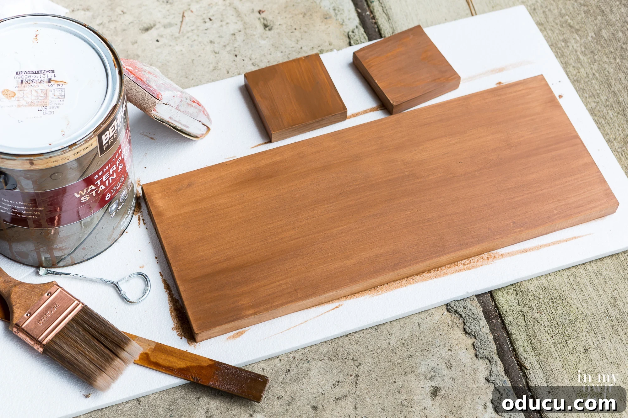 Supplies neatly arranged for making a modern house address plaque, including numbers, wood, and tools.