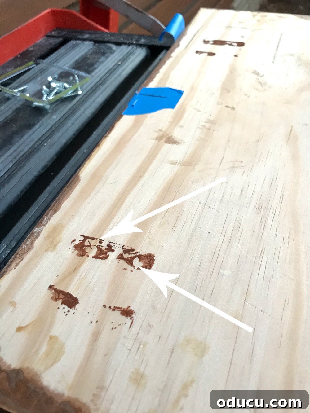 Back of an address plate showing paint marks from the hangers, indicating where to attach the screw-in components.