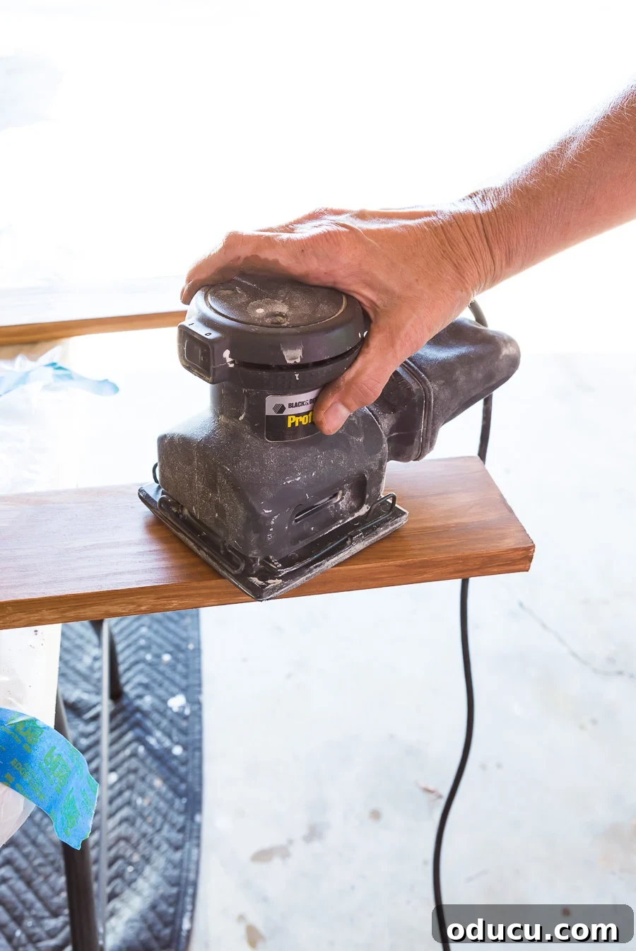 How to stain and prep wood slats by sanding for optimal finish, crucial for a DIY slat wall.