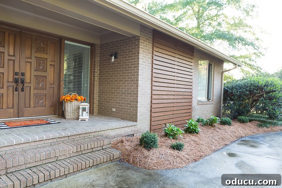 After image of an exterior wood accent wall on the front of a brick home, demonstrating a successful DIY project.