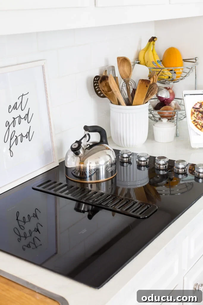 Flawless Finish: Repairing Painted Kitchen Counter Scratches and Dings 3 New black drop-in KitchenAid cooktop, a sleek upgrade for the kitchen.