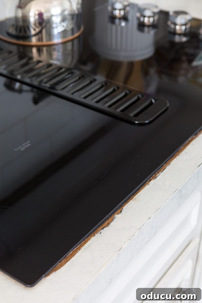 Flawless Finish: Repairing Painted Kitchen Counter Scratches and Dings 5 Painted counter showing the exposed original Formica after a new cooktop was installed.