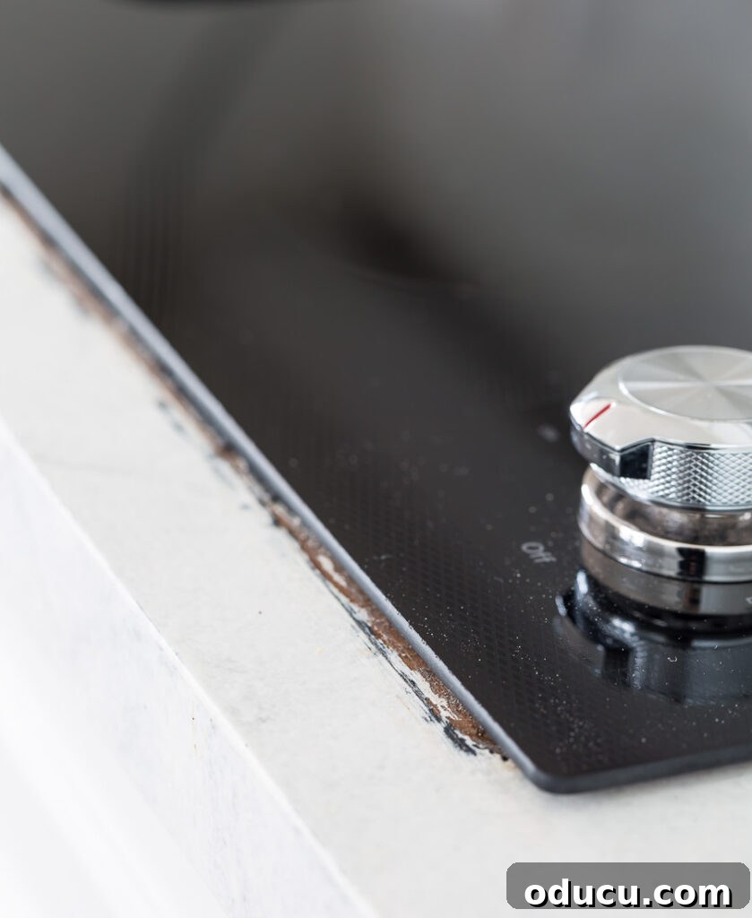 Flawless Finish: Repairing Painted Kitchen Counter Scratches and Dings 6 Painted kitchen counter showing damage incurred during new cooktop installation.