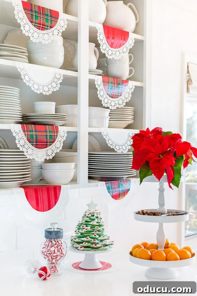 White kitchen with open shelves. Red plaid doilies hanging from the shelves, showcasing simple Christmas decorating ideas on a budget