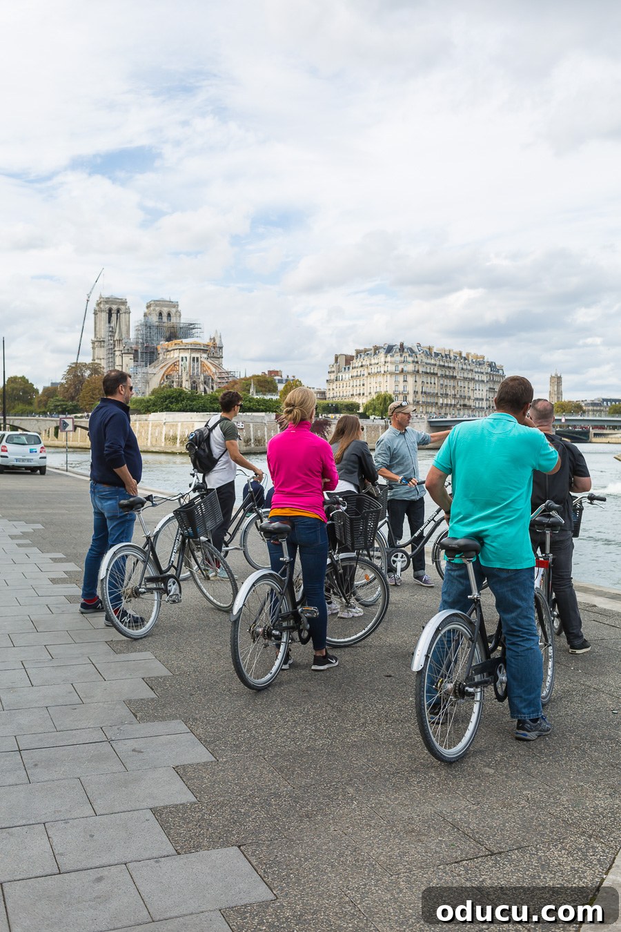 Discovering Paris on Foot 4 Bicycle riders stopping along the Seine in Paris to listen to a tour guide.