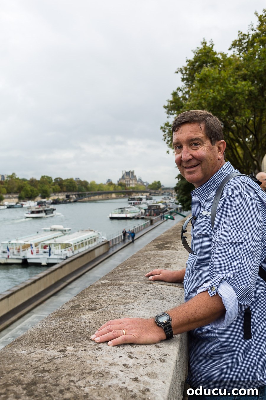 Discovering Paris on Foot 8 Ed standing along the Seine