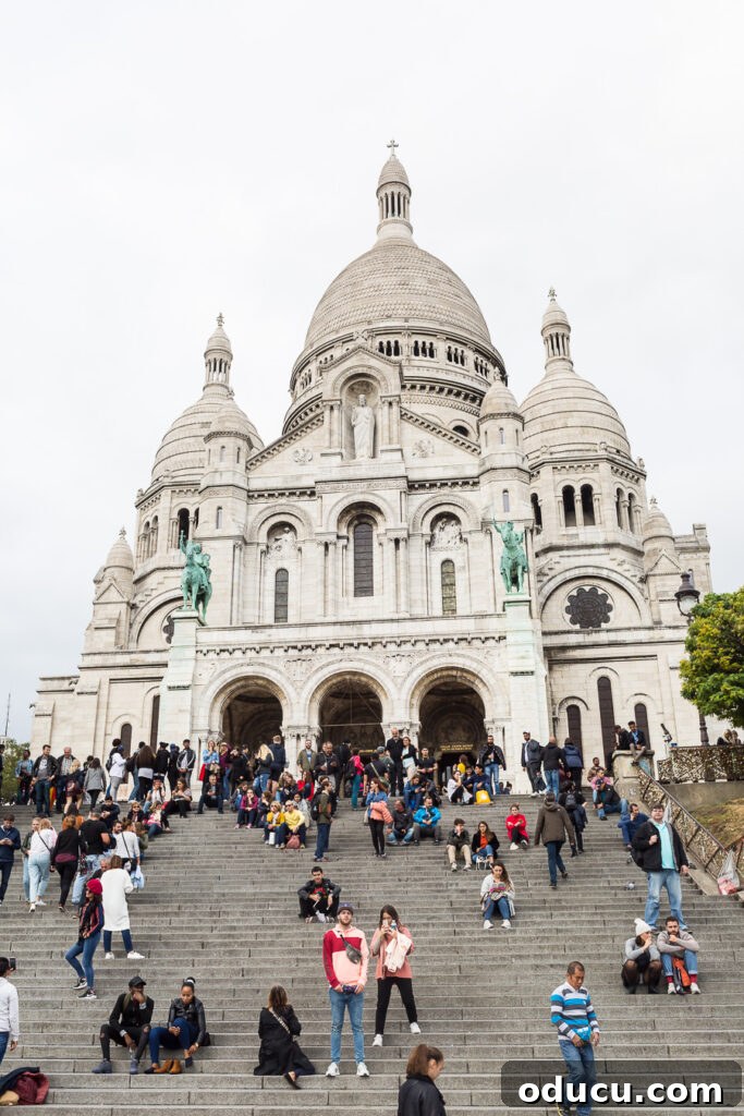 Ascending Paris's Masterpiece 15 The stunning white domes of the Sacré-Cœur Basilica standing proudly atop Montmartre in Paris, France.