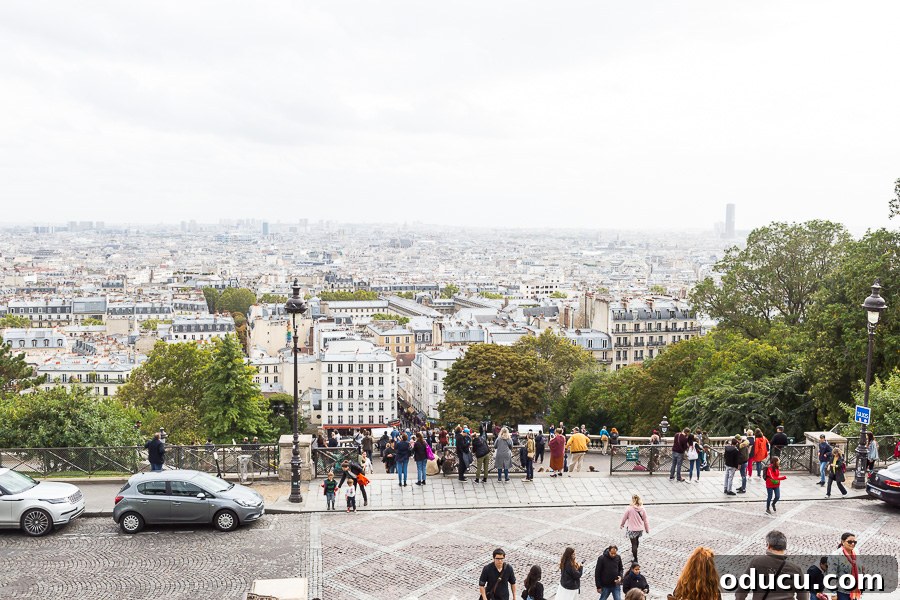 Ascending Paris's Masterpiece 18 A picturesque view looking down from Sacré-Cœur, capturing the charming architecture and streets of Paris below.