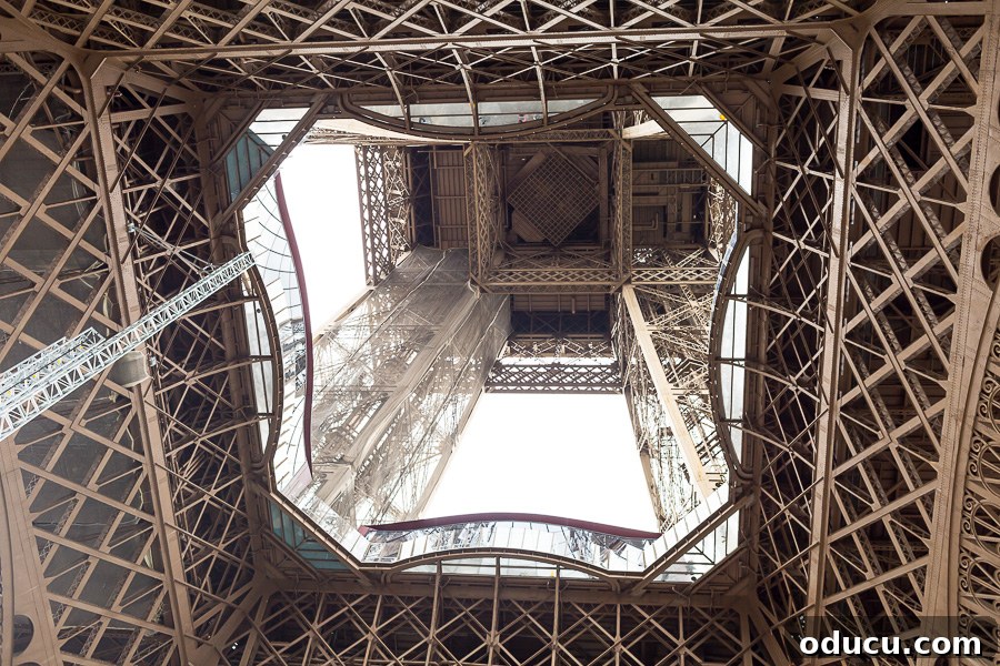 Ascending Paris's Masterpiece 3 Standing directly under the Eiffel Tower, gazing up into its complex internal structure of iron beams and rivets.