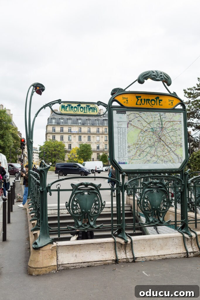 Ascending Paris's Masterpiece 21 A beautifully designed Art Nouveau Metro station entrance, showcasing Hector Guimard's distinctive architectural style in Paris.