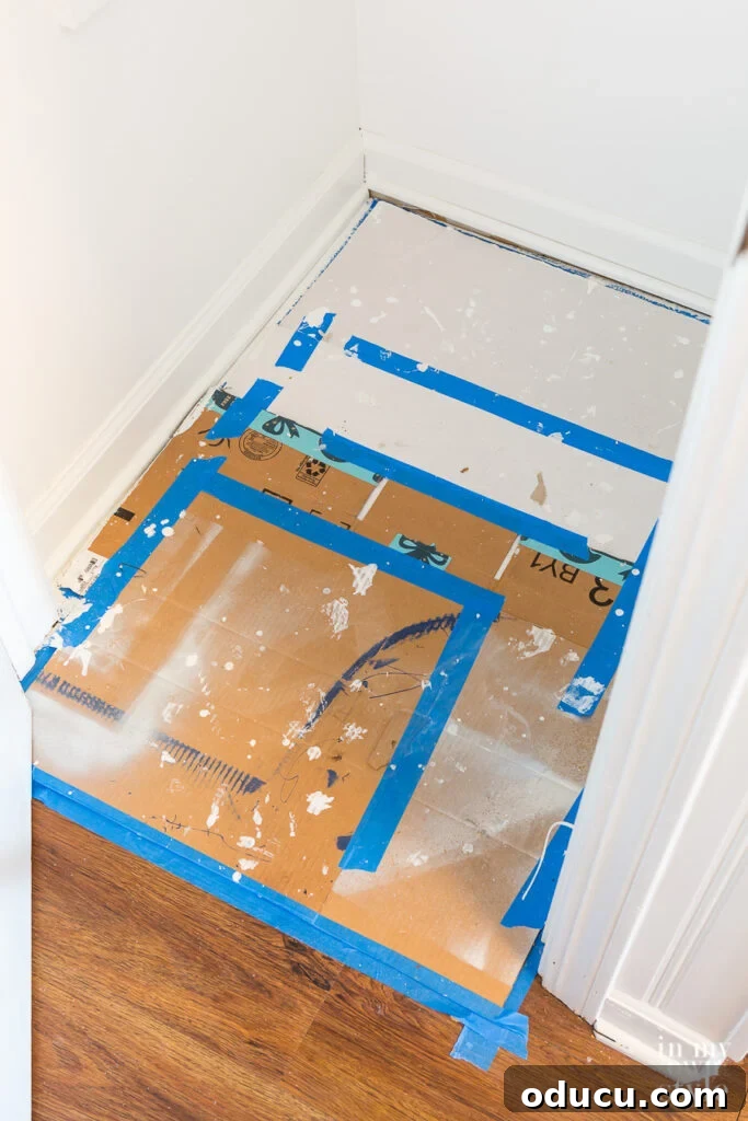 Why Primer Is Essential For Painting Over Stained Paint 11 Broken down cardboard boxes taped together on the floor of a closet, used as a secure drop cloth during painting.