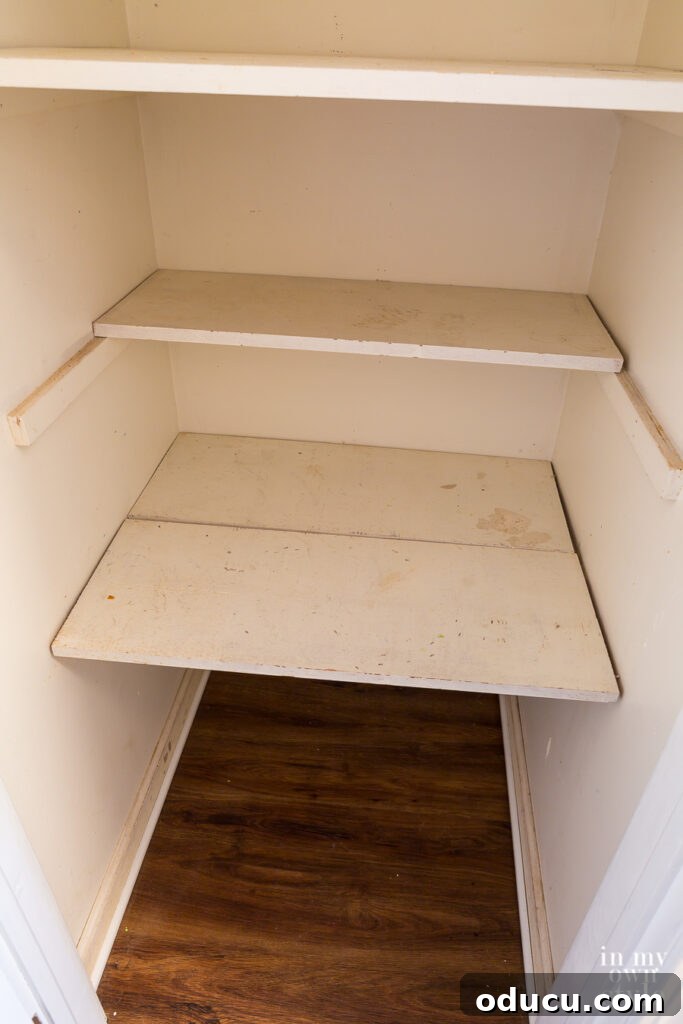 Why Primer Is Essential For Painting Over Stained Paint 5 A small hall closet showing stained walls and shelves, prepared for a makeover using primer and paint.