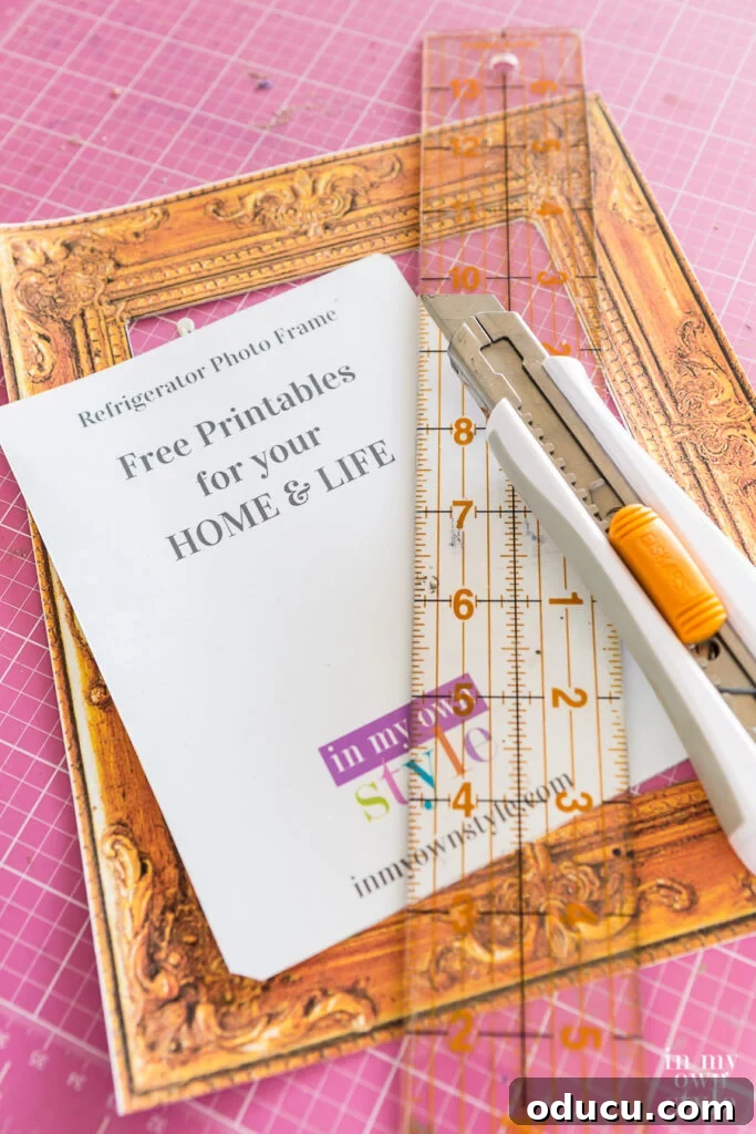 Close-up view of someone cutting the inside opening of a free printable photo frame with a craft knife and ruler.