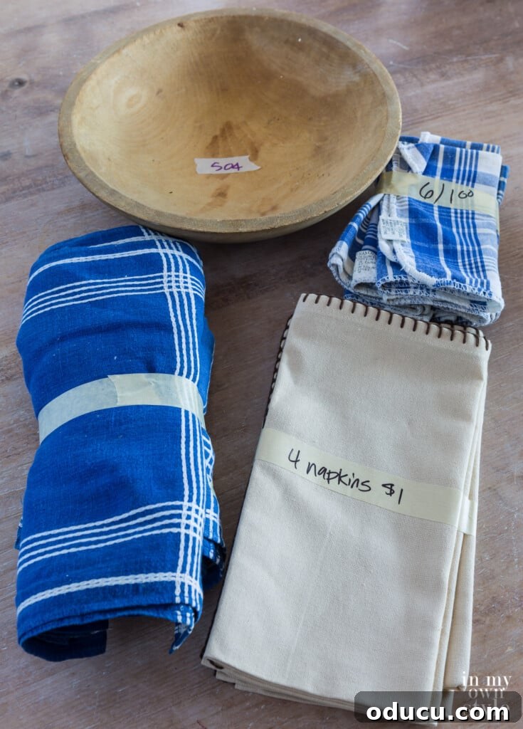 Decorating Magic for Just $23 11 An artfully arranged collection of church bazaar finds: blue and white table linens and a rustic wood bowl.