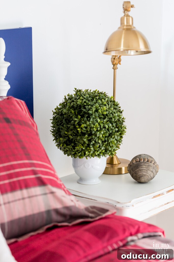 Spare Room to Serene Sanctuary 4 Beside table in guest room with red plaid color scheme, creating a harmonious and warm bedside area.