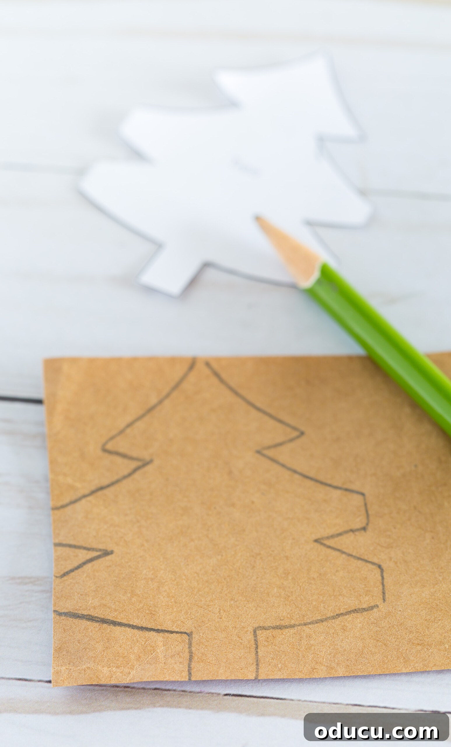 Craft Your Own Christmas Tree Paper Chain 9 How to trace a template of a Christmas tree pattern on to a strip of paper.