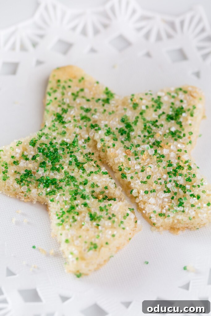 Dazzling Christmas Cookie Decorating Tricks 3 Close-up of a star-shaped Christmas sugar cookie with green and white sprinkles, highlighting its festive decoration.