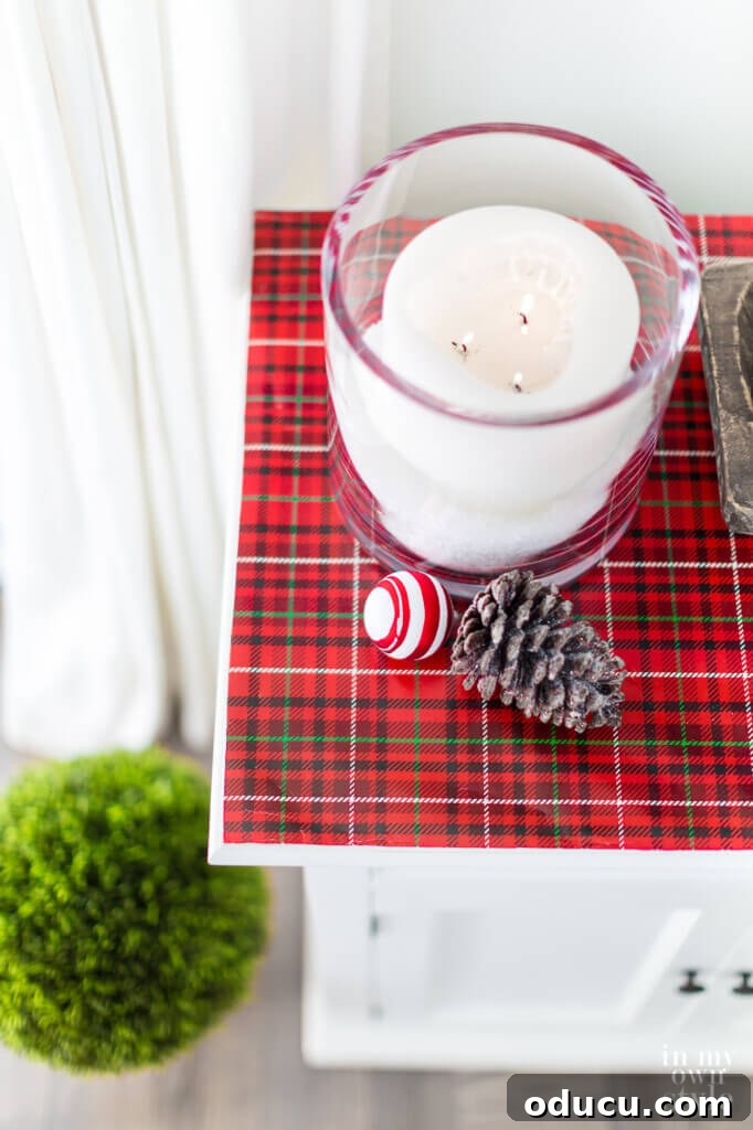 Quick Christmas Home Decor Hacks When Time is Tight 23 Sideboard decorated for Christmas on a budget using gift wrap.