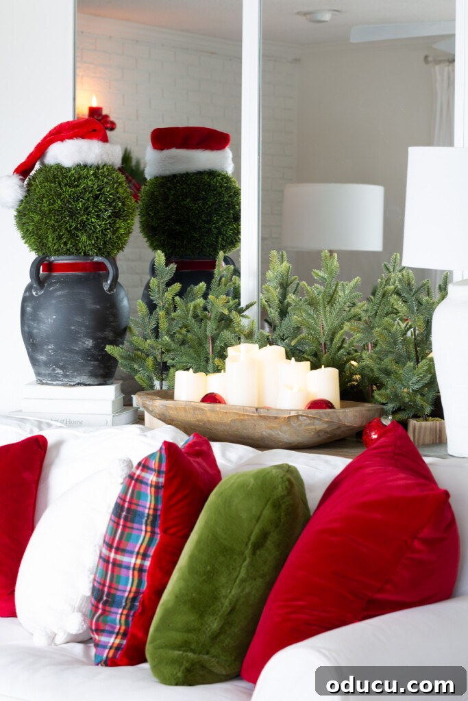 Quick Christmas Home Decor Hacks When Time is Tight 4 Large topiary ball on black vase to resemble Santa makes for easy holiday decor.