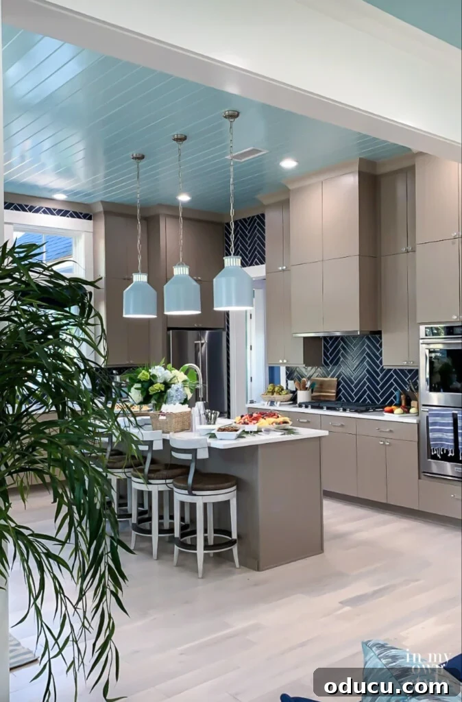 HGTV Dream Home 2020 Revealed 6 A wide view of the HGTV Dream Home kitchen from the adjacent living room, highlighting the open-concept design and cohesive coastal aesthetic