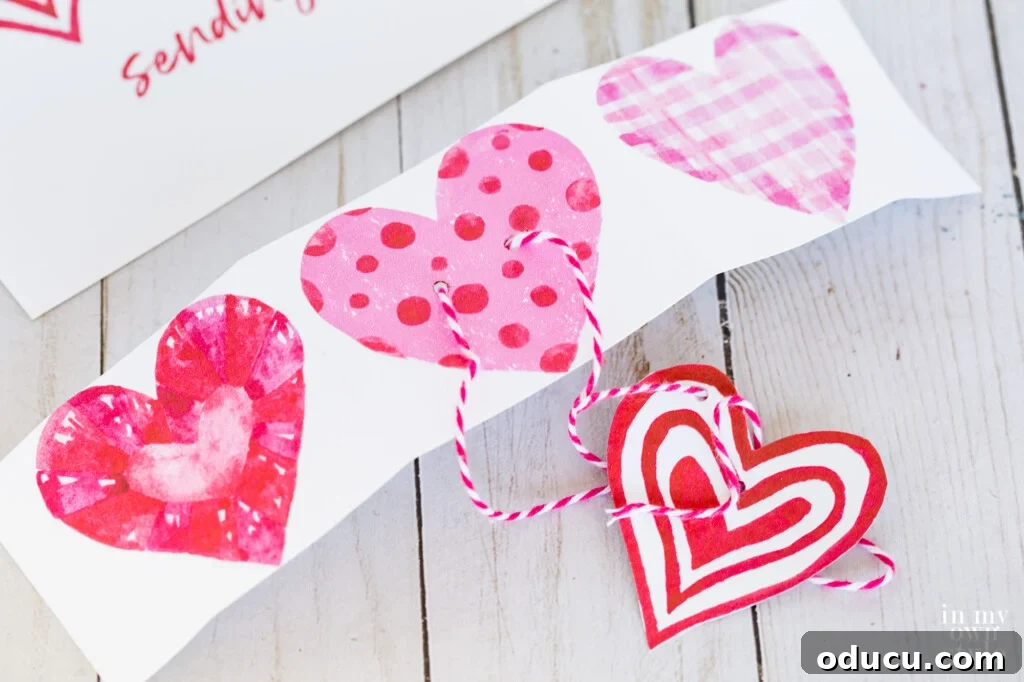 A strip cutout of 3 hearts from a free printable to use as a gift tag.