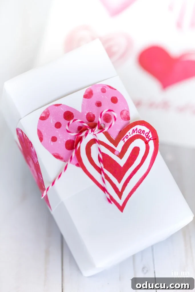 Valentine gift wrapping idea using a sheet of free printable watercolor hearts.