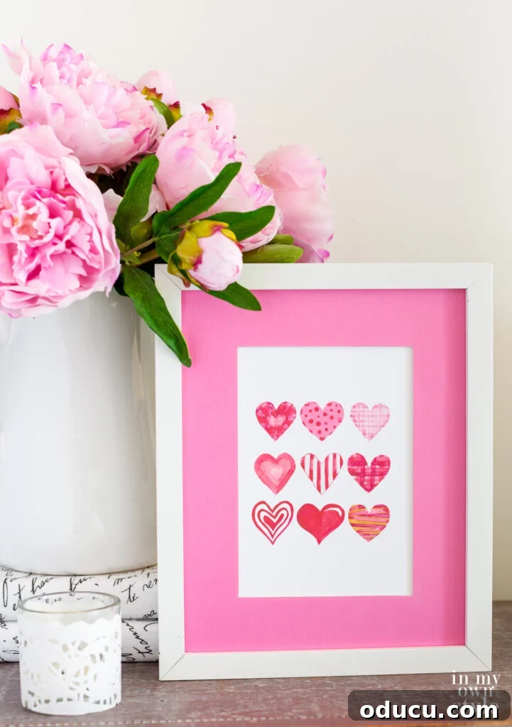 Free printable art of 9 Valentine hearts in a white frame.