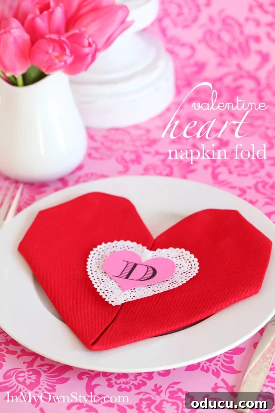 10 Heartfelt Valentine's Ideas for Everyone You Cherish 4 Step-by-step guide to folding a napkin into a charming heart shape for Valentine's Day table settings.