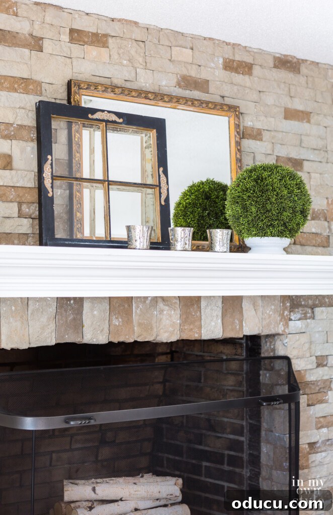 Effortless Home Refresh 7 AirStone fireplace and mantel decorated for Winter, demonstrating creative item placement.