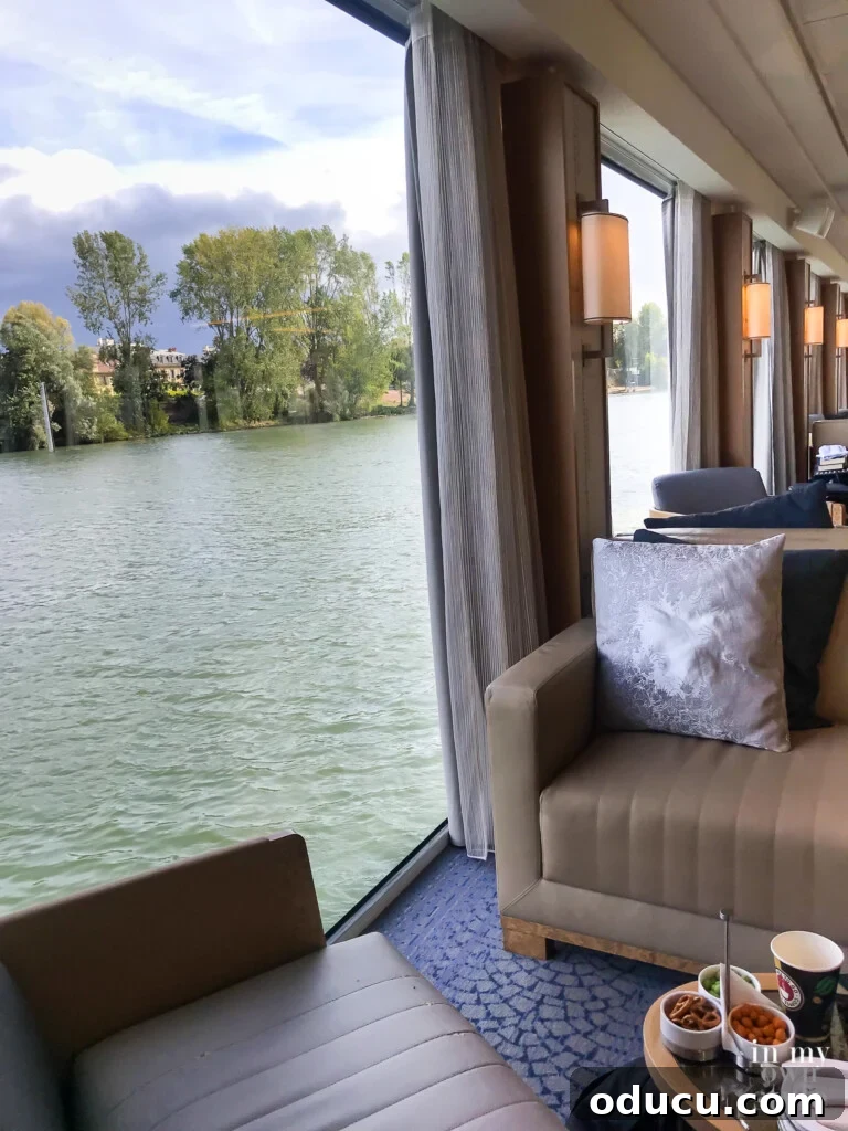 An Iconic Viking Journey Along the Seine 11 Panoramic view from the main lounge area on a Paris to Normandy Viking River Cruise, showcasing scenic river vistas.
